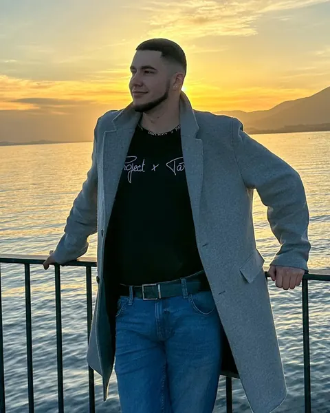 Jack Emery, founder of KodeNet, by the water at sunset